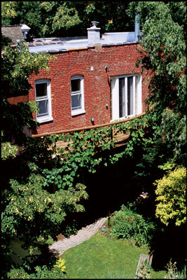 
The curving balcony on the house’s south side provides a wonderful view of the entire garden, and it serves as the focal point for Ray’s annual August garden party. Grapes ripen on the vines covering the railing, attracting birds eager for a feast.
